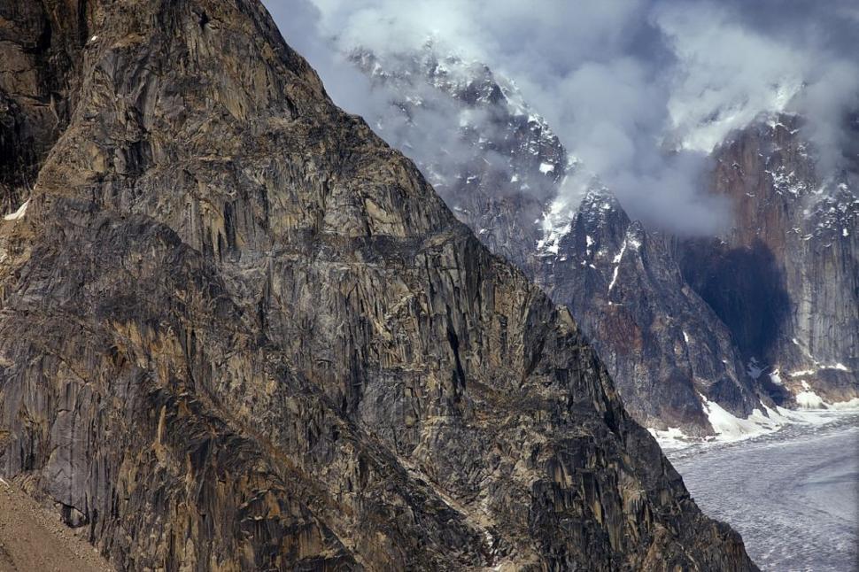 Free Image of Snowboarder Descending Steep Mountain 