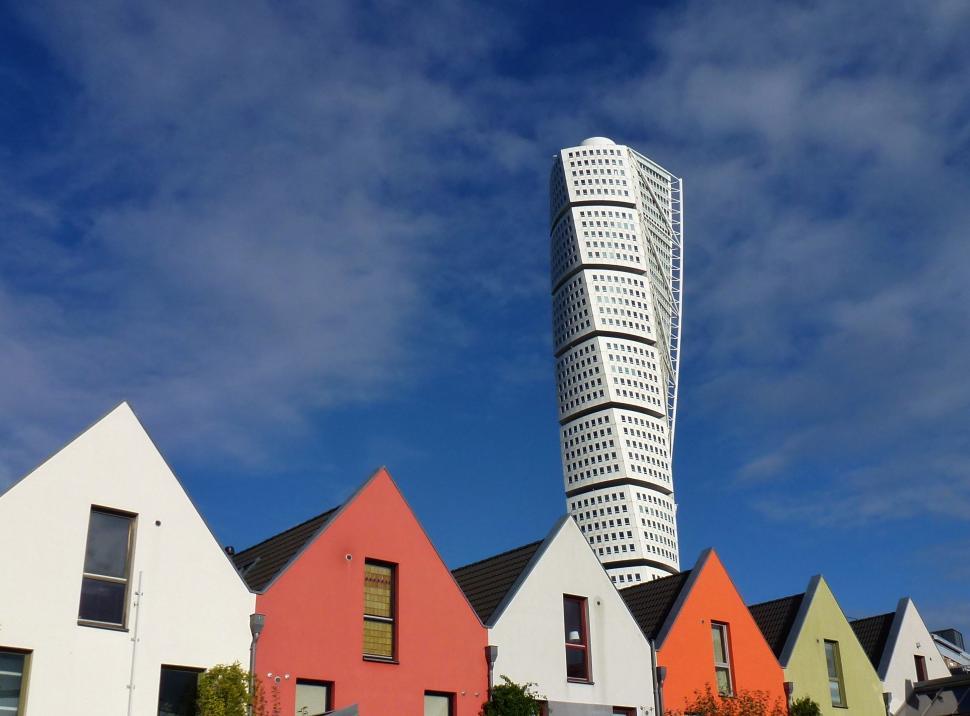 Free Image of Row of Houses With Tall Building in Background 