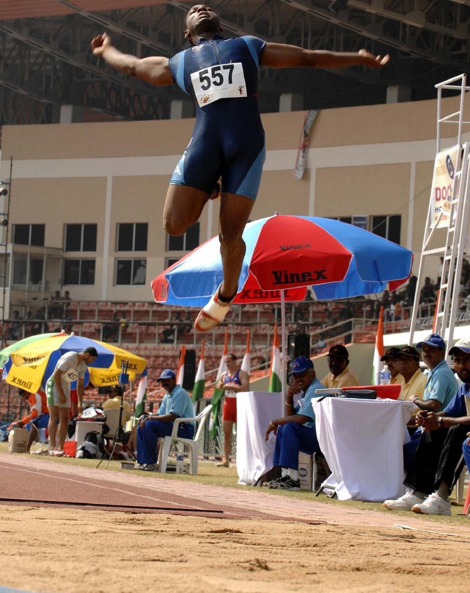 Free Image of Man Jumping in the Air With Umbrella 
