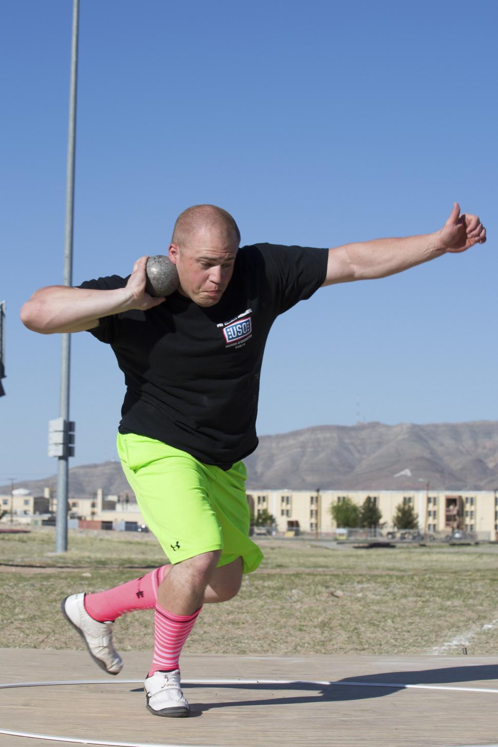 Free Image of Man in Black Shirt and Neon Green Shorts Performing Trick With Skateboard 