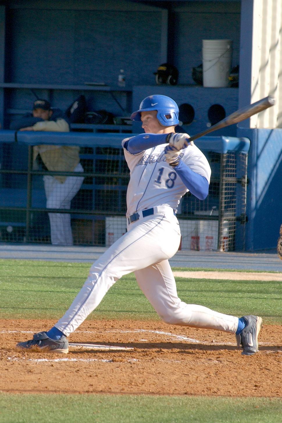 Free Image of Baseball Player Swinging Bat on Field 