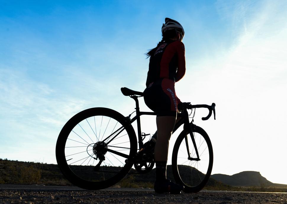 person-standing-next-to-bike-on-dirt-road.jpg