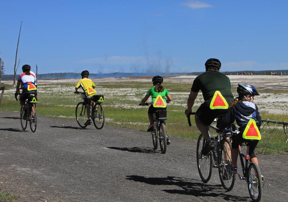 Free Image of Group of People Riding Bikes Down a Road 