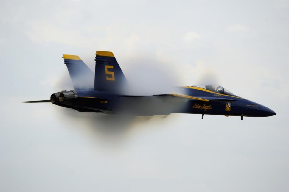 Free Image of Fighter Jet Flying Through Cloudy Sky 