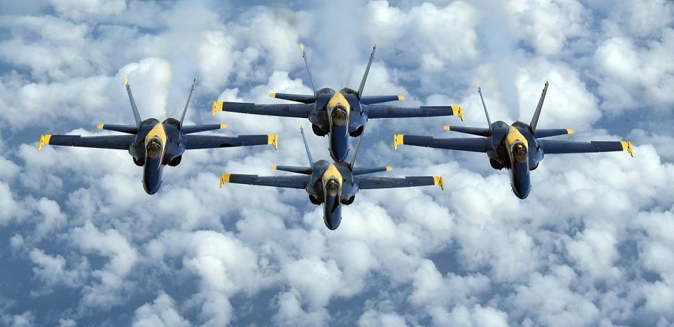 Free Image of Squadron of Fighter Jets Flying Through Cloudy Sky 