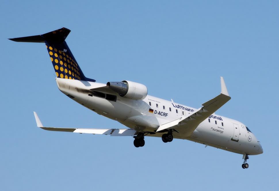 Free Image of White and Black Airplane Flying in the Sky 