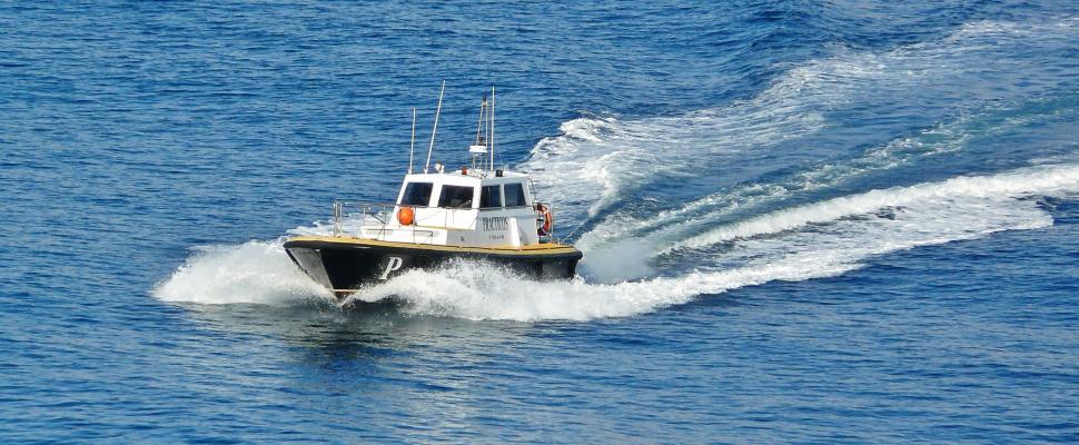 Free Image of White and Black Boat in the Middle of the Ocean 