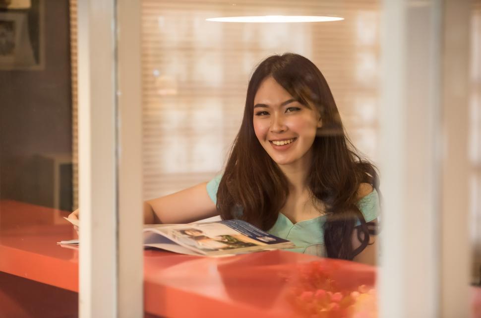 Free Image of Woman Sitting at Table in Front of Window 
