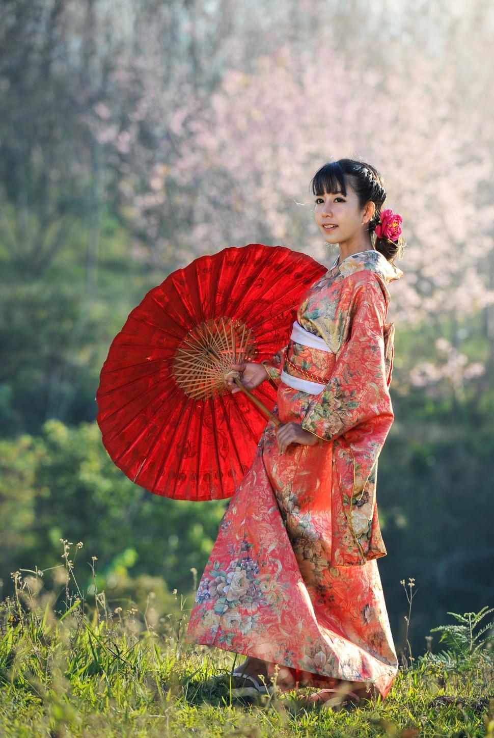 Free Image of Woman in Kimono Holding Red Umbrella 