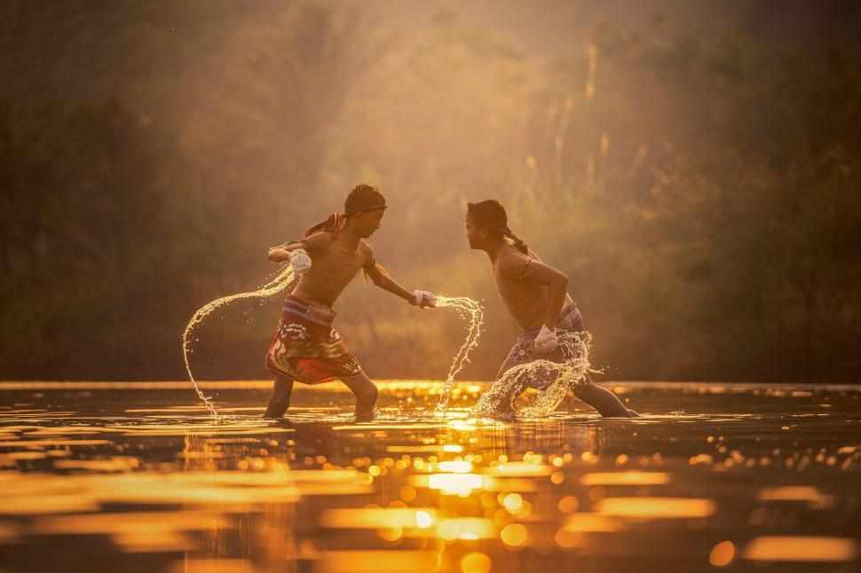 Free Image of Two People Standing in Water 