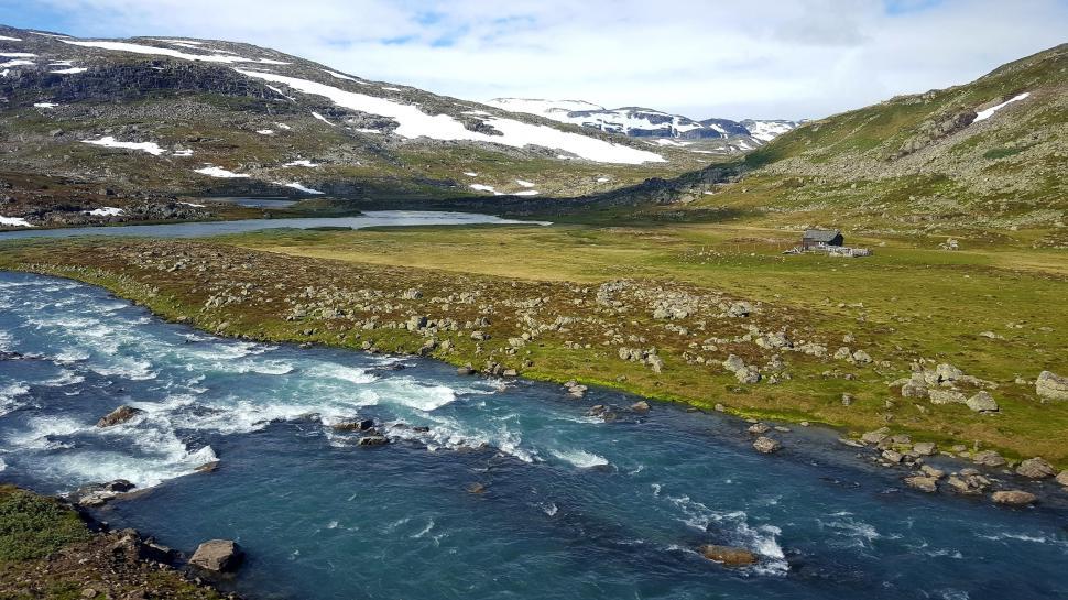 Free Image of River Flowing Through Lush Green Hillside 