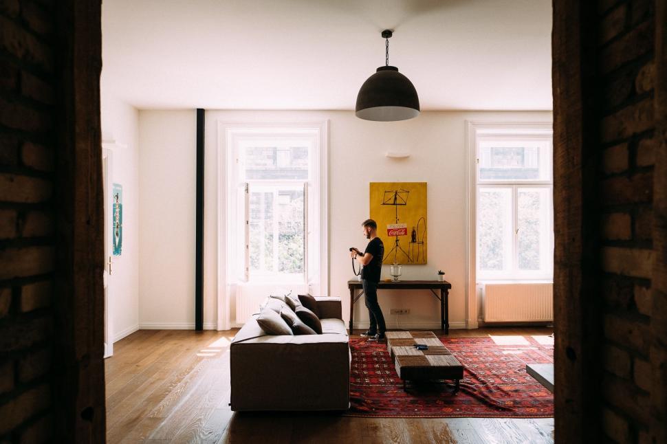 Free Image of Person Standing Next to Couch in Living Room 