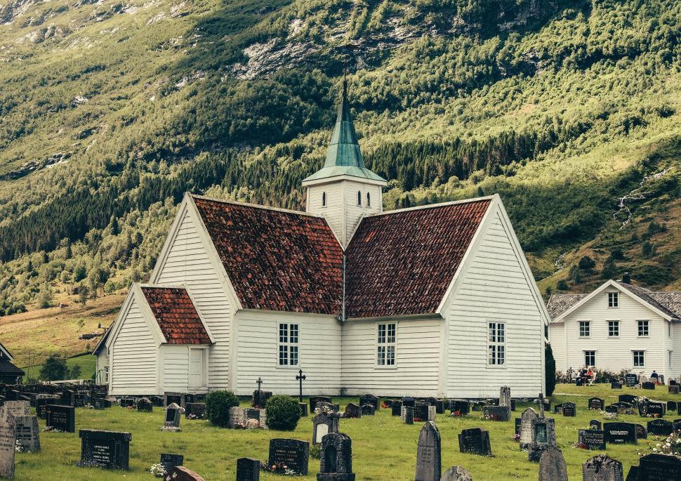 Free Image of White Church With Steeple Surrounded by Graves 
