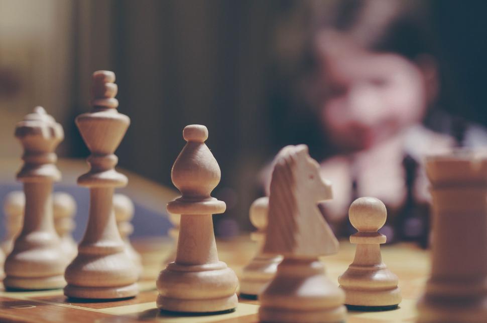 Free Image of Group of Chess Pieces on Wooden Table 