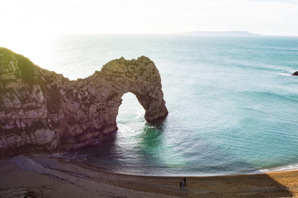 Free Image of Person Standing on Beach Next to Ocean 