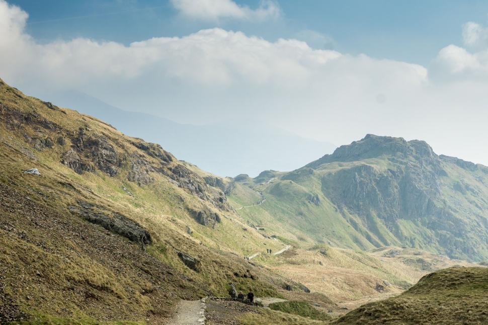 Free Image of Man Riding Motorcycle Down Dirt Road 