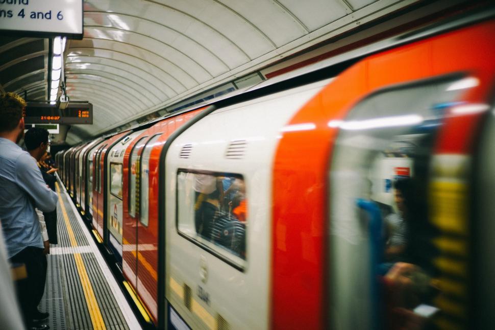 Free Image of Group of People Standing Next to a Train 