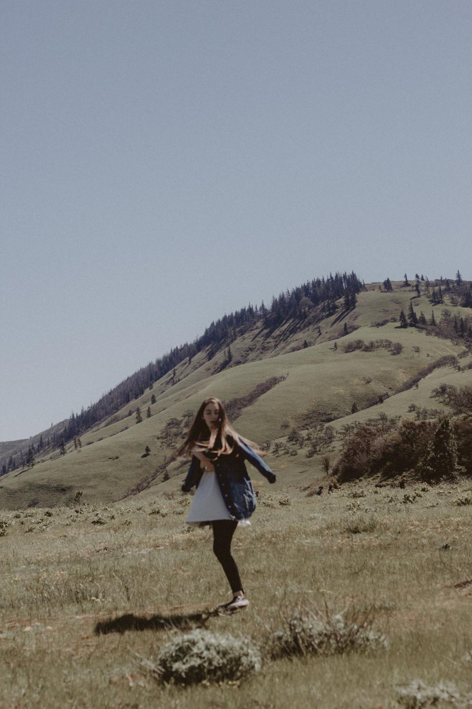 Free Image of Woman Standing in Field With Kite 