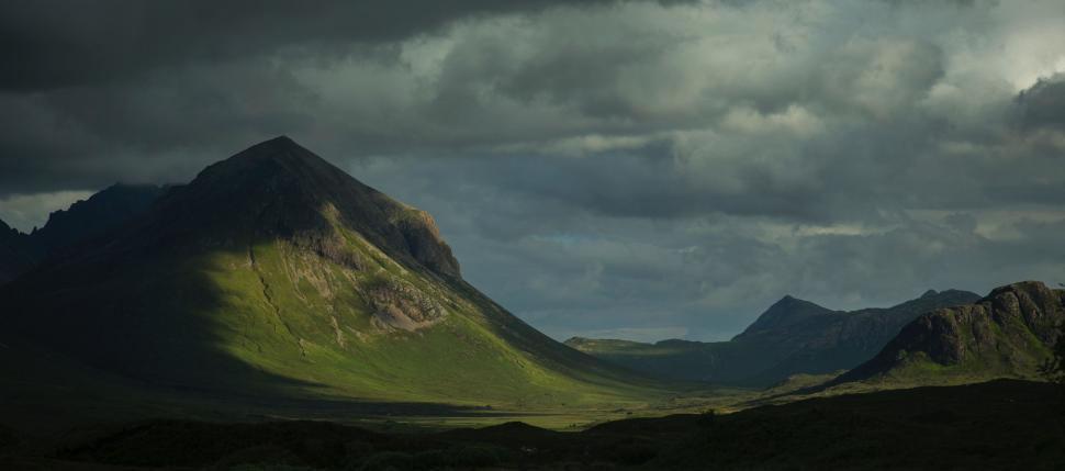 Free Image of Majestic Mountain Range Beneath Cloudy Sky 