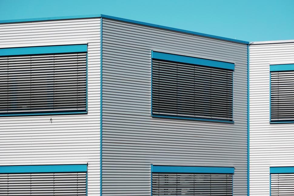 Free Image of White Building With Blue Trim and Windows 