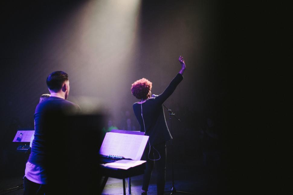 Free Image of Couple Standing in Front of Piano 