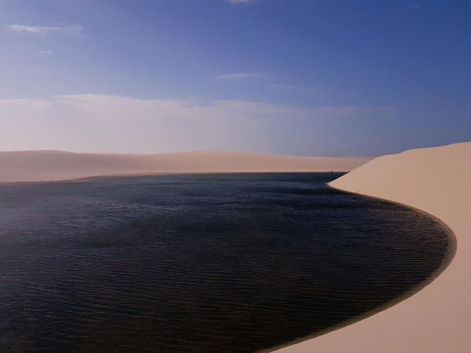 Free Image of Large Body of Water Surrounded by Sand Dunes 