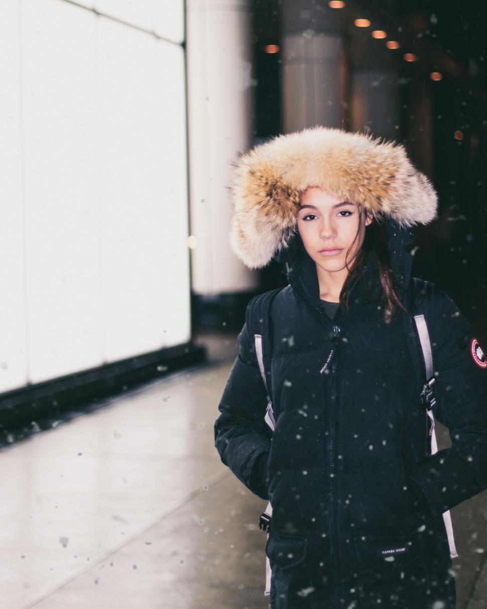 woman-walking-down-a-street-in-fur-hat.j