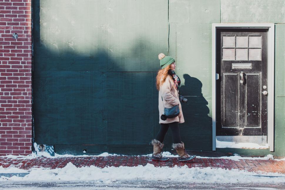 Free Image of Woman Standing in Front of Green Building 