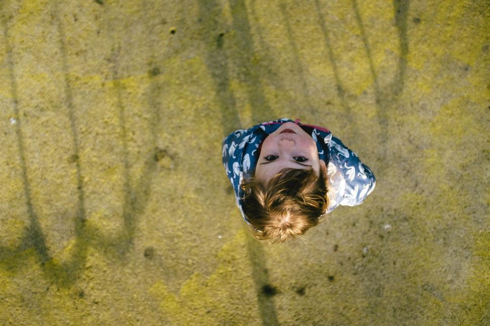 Free Image of Person in Blue and White Shirt Standing on Sand 