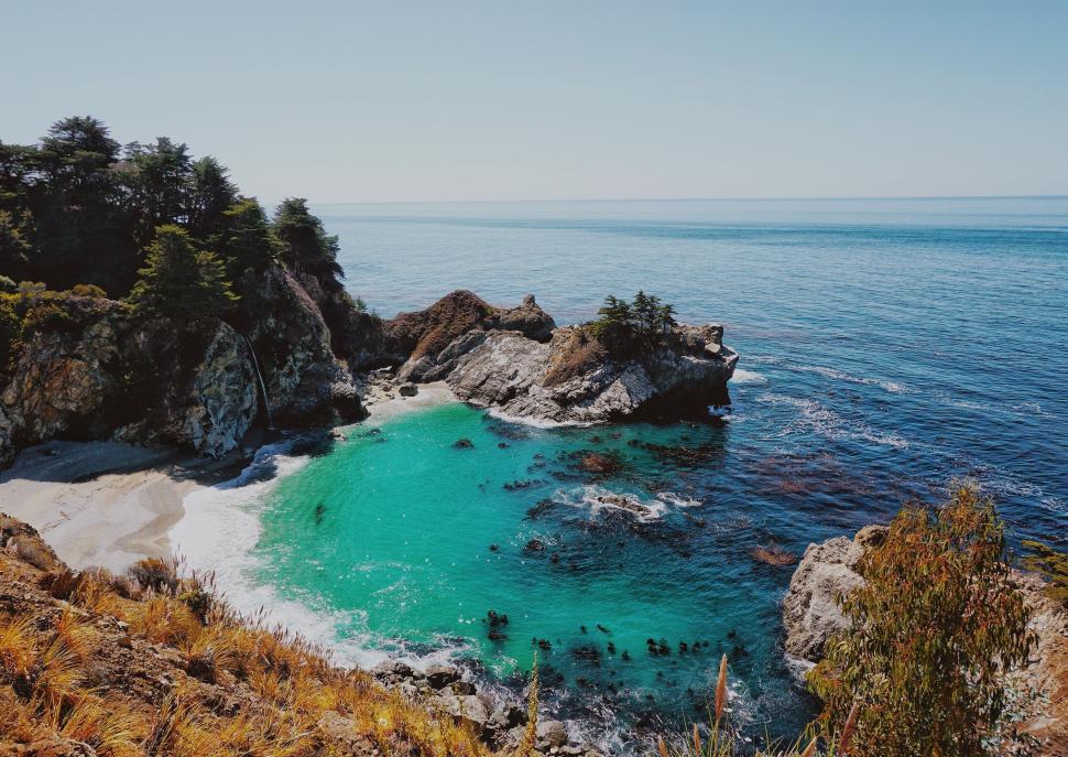 Free Image of Rocky Cliff Surrounding Water Body 
