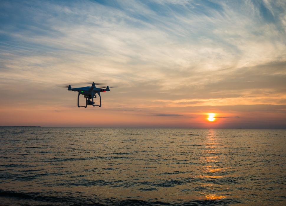 Free Image of Small Plane Flying Over Large Body of Water 