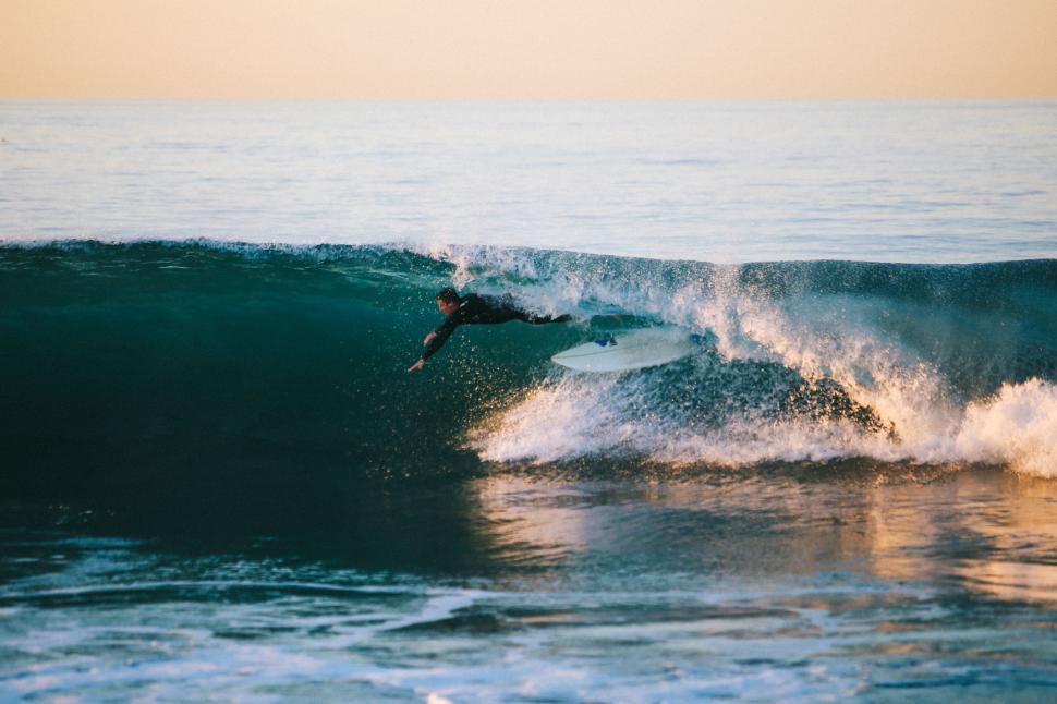 Free Image of Man Riding Wave on Surfboard 