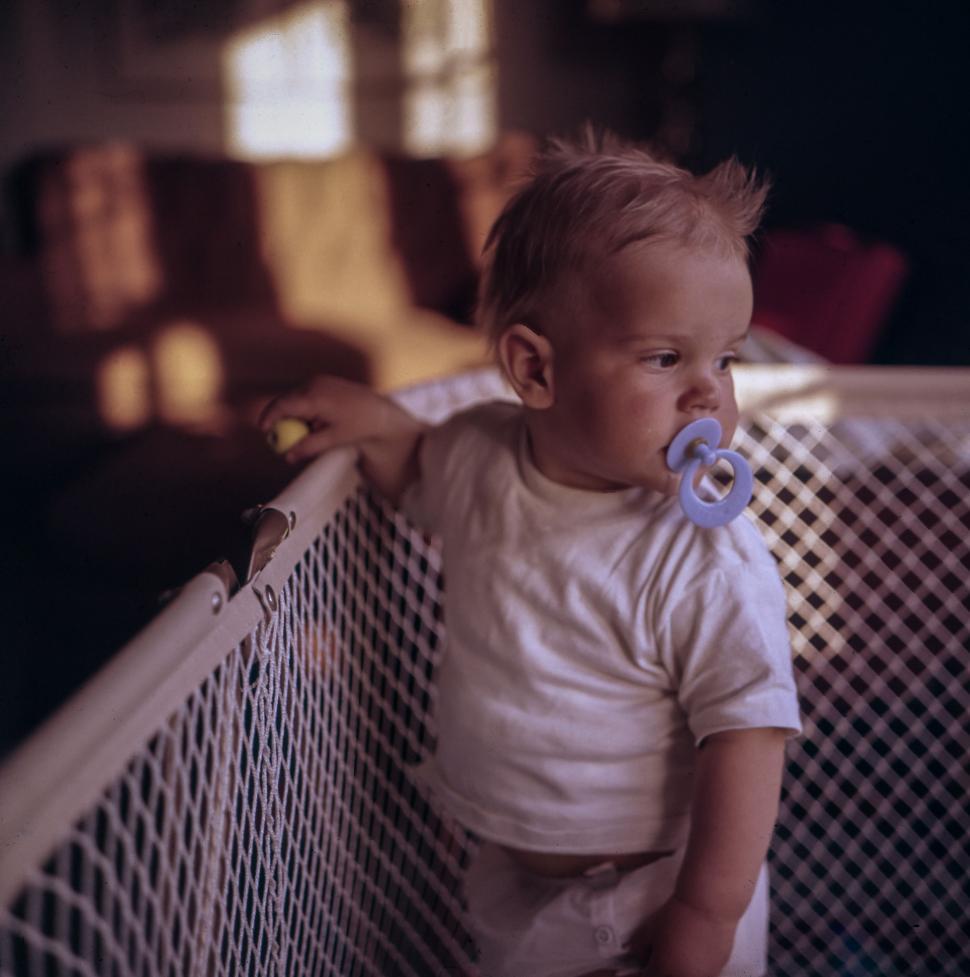 Free Image of Baby in Crib With Pacifier 