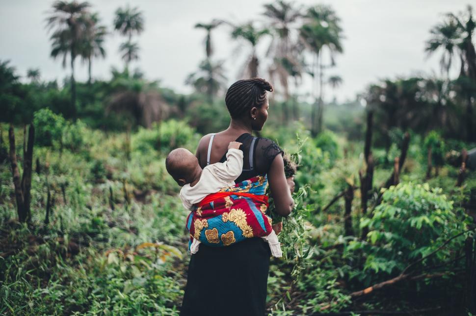 Free Image of Woman Carrying Baby in Colorful Backpack 