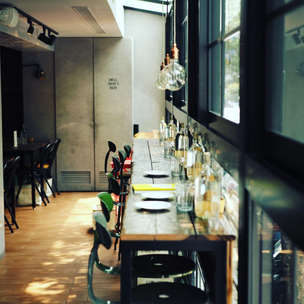 Free Image of Many Bottles on Long Table in Restaurant 