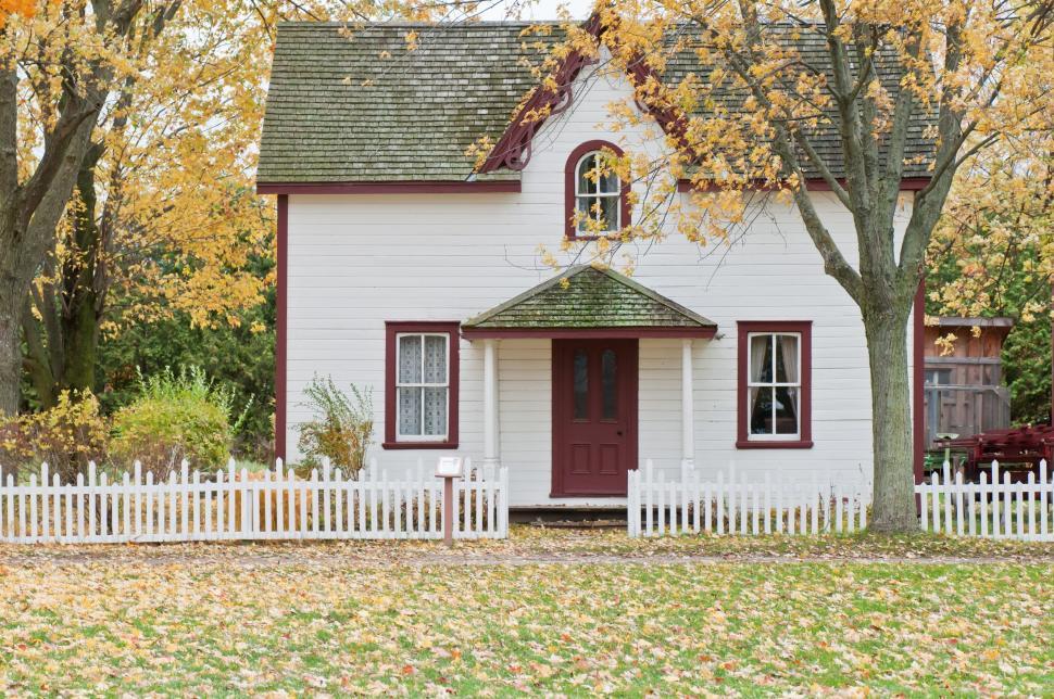 Free Image of White House With Red Door and White Picket Fence 