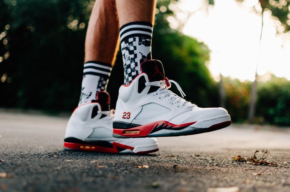 Free Image of Person Wearing White and Red Sneakers and Socks 