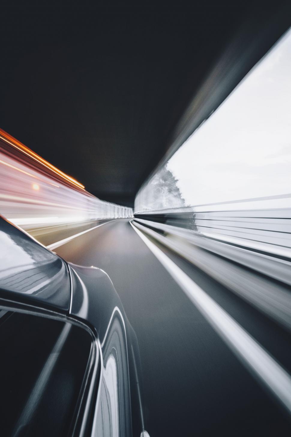 Free Image of Car Driving Down Highway Next to Tunnel 