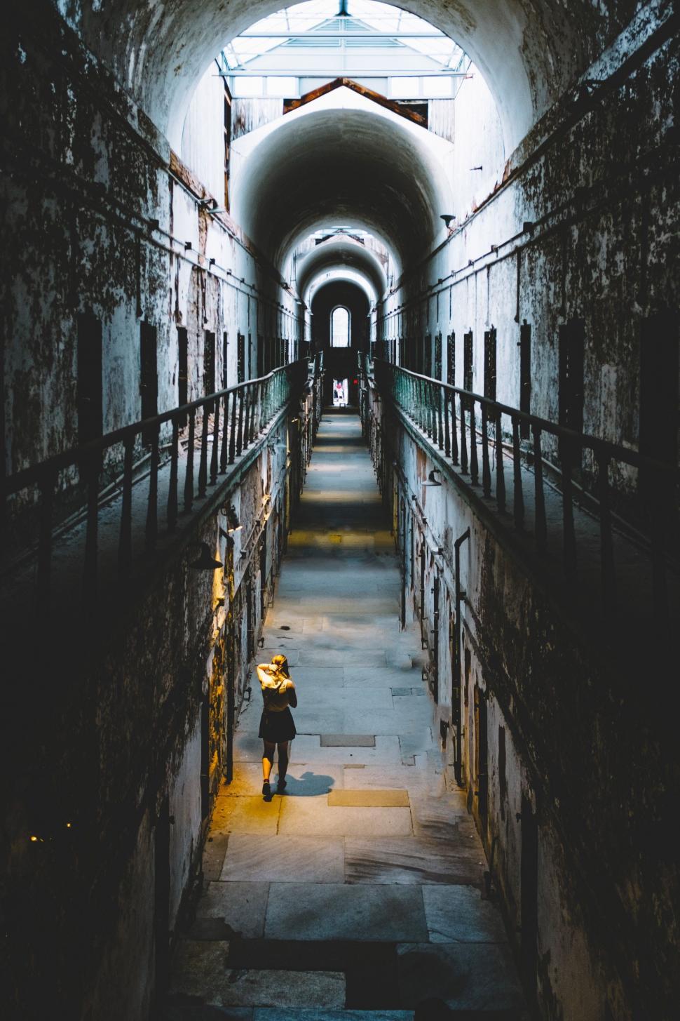 Free Image of Person Walking Down a Dark Tunnel 