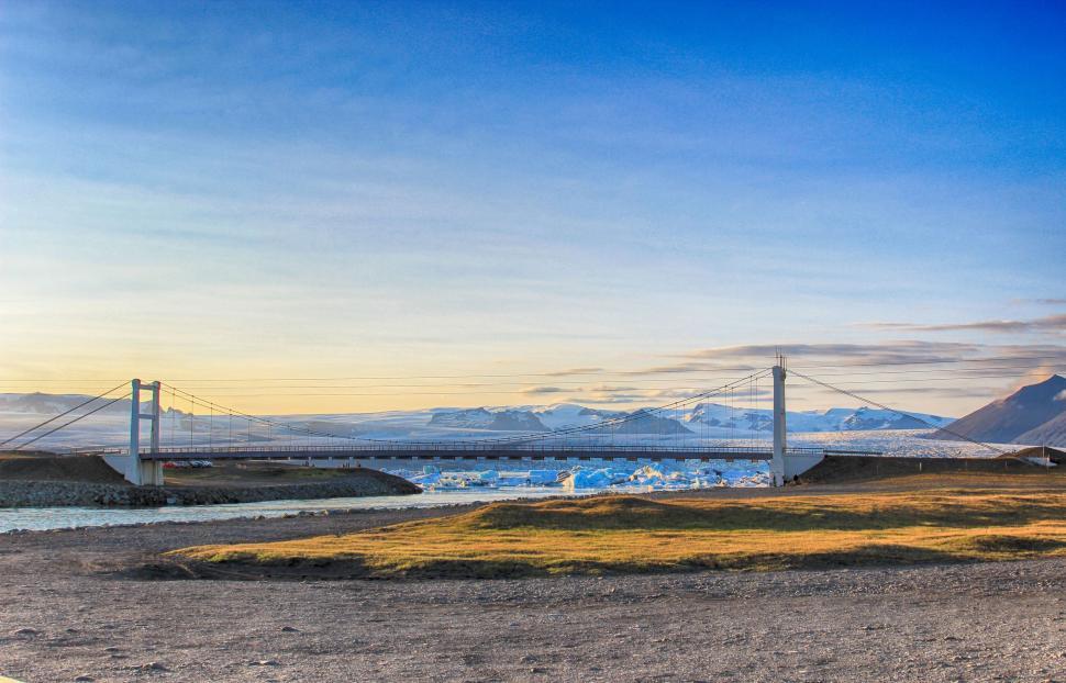 Free Image of Bridge Crossing Body of Water With Mountainous Background 