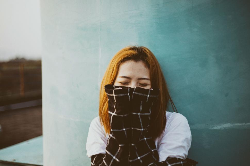 Free Image of Woman With Red Hair Wearing Black and White Checkered Scarf 