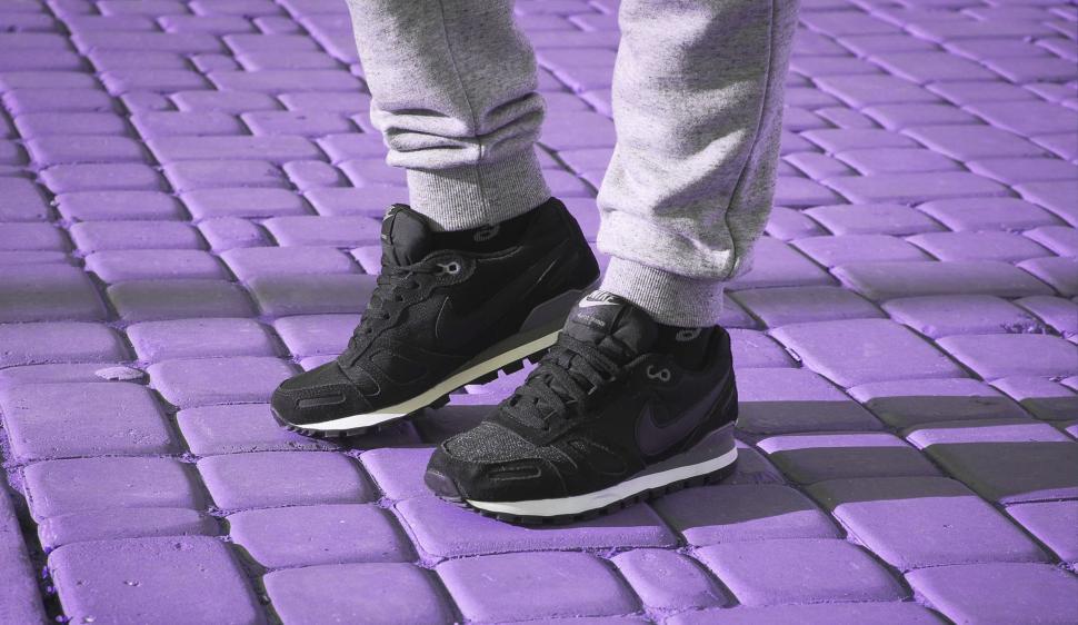 Free Image of Person Standing on Top of Purple Brick Floor 