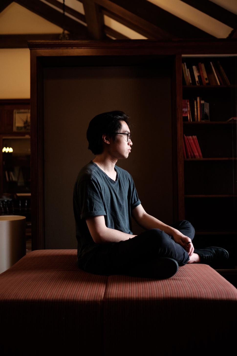 person-sitting-on-bed-in-room.jpg