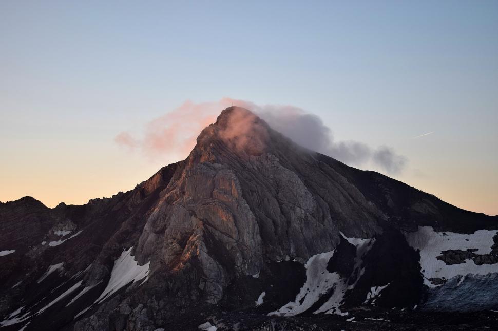 Free Image of Snow-Covered Mountain Towering Under Blue Sky 