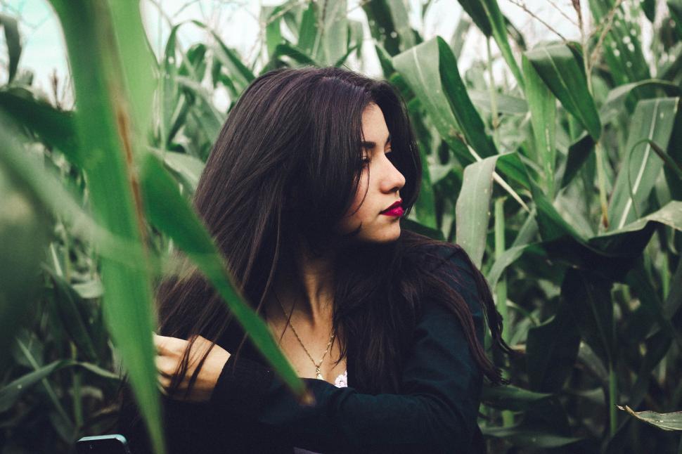 Free Image of Woman Standing in a Field of Corn 