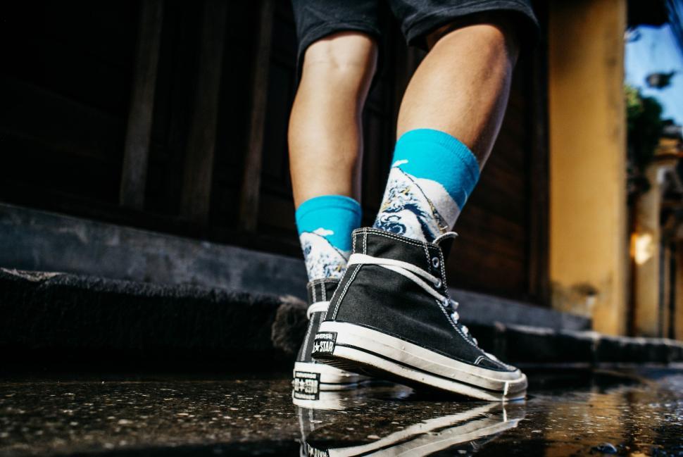 Free Stock Photo of Person Wearing Blue Socks and Black and White Shoes