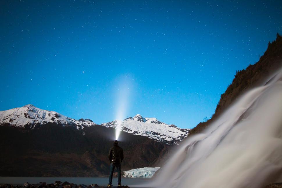 Free Image of Person Standing in Front of Mountain Under Blue Sky 