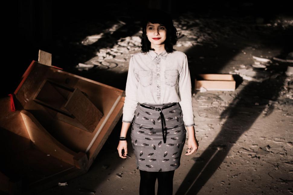 Free Image of Woman Standing Next to Pile of Luggage 