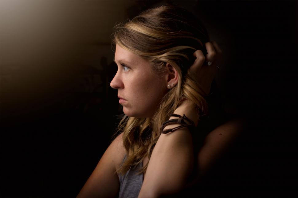 woman-sitting-in-chair-with-hand-on-head.jpg