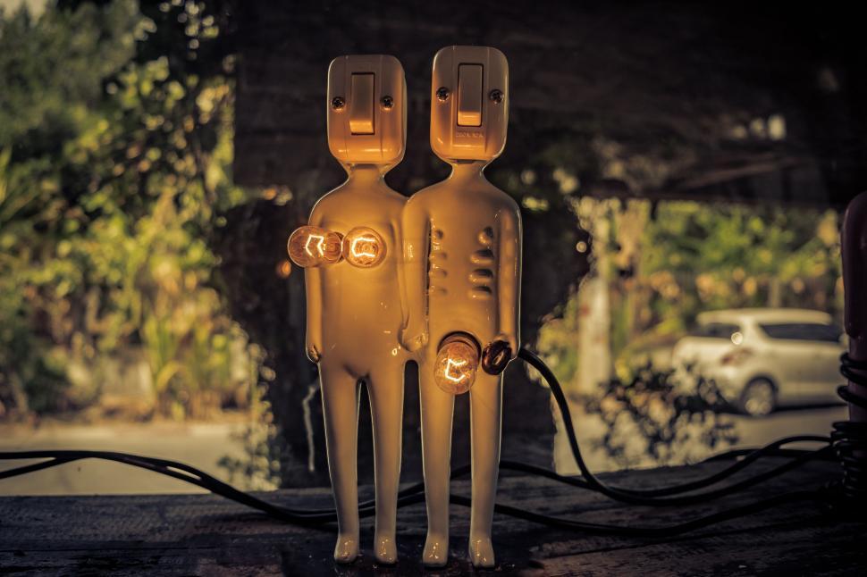 Free Image of Two Yellow Figures Sitting on Table 